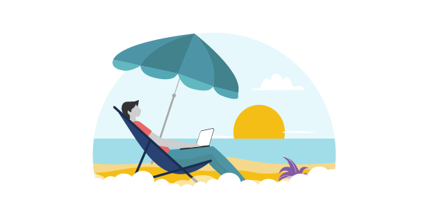 A guy working in his laptop on a beach